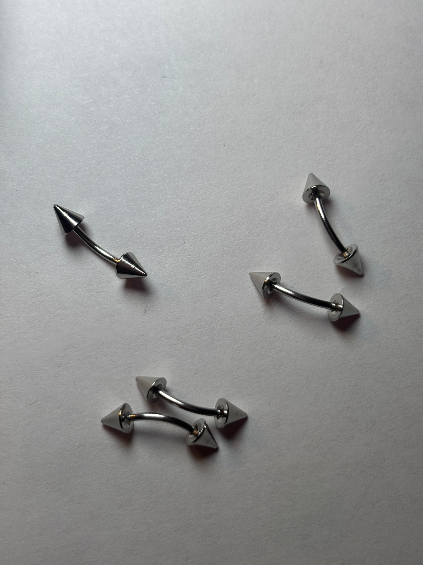 Small stainless steel pointed edge piercing 